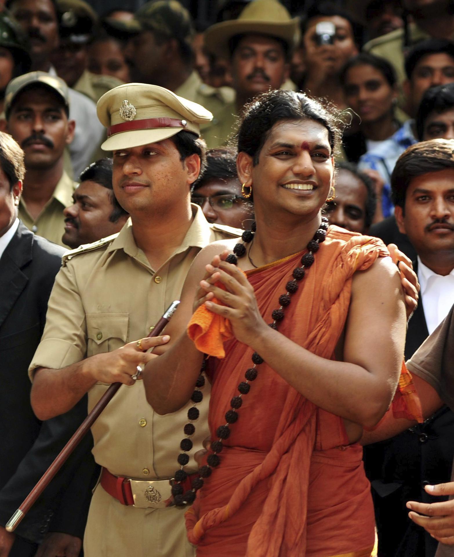 (FILE) Indian Police escort the controversial Hindu self-styled godman Swami Nithyananda (R) on the outskirts of Bangalore, India. EPA/EFE/FILE/JAGADEESH NV