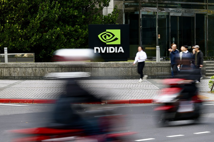 People walk past the NVIDIA logo in Taipei, Taiwan