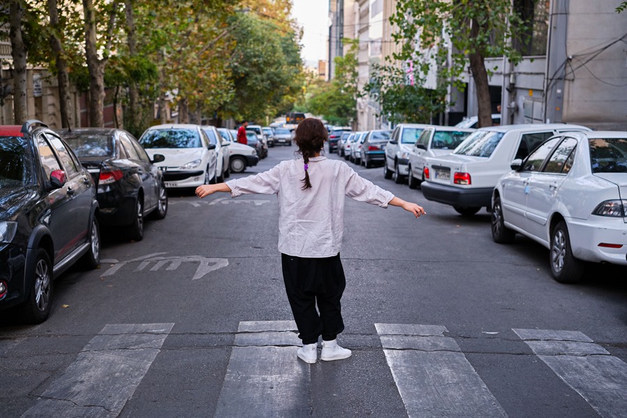 An Iranian student took off her clothes after being attacked with a veil